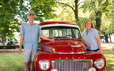 Zwei Personen stehen neben einem roten Volvo Oldtimer auf der Lindau Klassik Rallye.