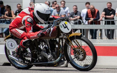 Fahrer in roter Lederkombination f&auml;hrt auf &auml;lterem Motorrad bei Klassikwelt Bodensee 2026