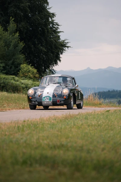 Schwarz-wei&szlig;er Oldtimer f&auml;hrt auf l&auml;ndlicher Strecke w&auml;hrend der Lindau-Klassik Rallye.