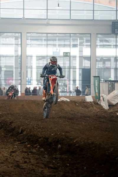 Motocrossfahrer springt mit KTM-Motorrad &uuml;ber H&uuml;gel auf der Motorradwelt 2026