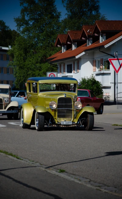 Oldtimer-Auto in Gelb f&auml;hrt auf einer Stra&szlig;e beim American-Dream-V8 Treffen