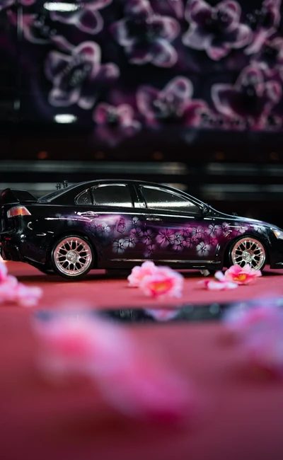 Schwarzes Auto mit pinken Blumen-Motiven auf der Tuning World Bodensee 2026