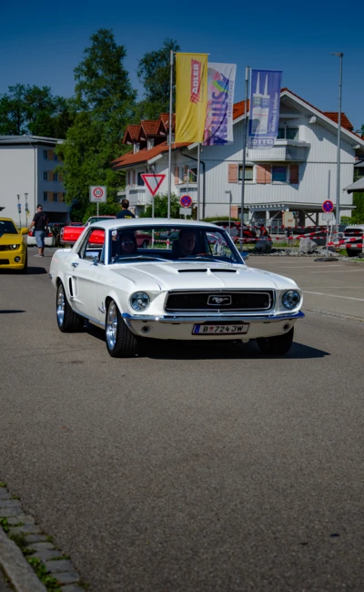 Wei&szlig;er Ford Mustang von 1967 f&auml;hrt auf Stra&szlig;e w&auml;hrend American-Dream-V8 Treffen