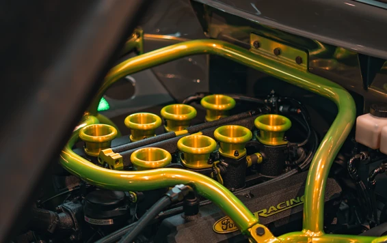 Engine modification detail, Tuning World Bodensee 2026. Detailaufnahme eines Motors mit gelben Ansaugtrichtern, Tuning World Bodensee 2026