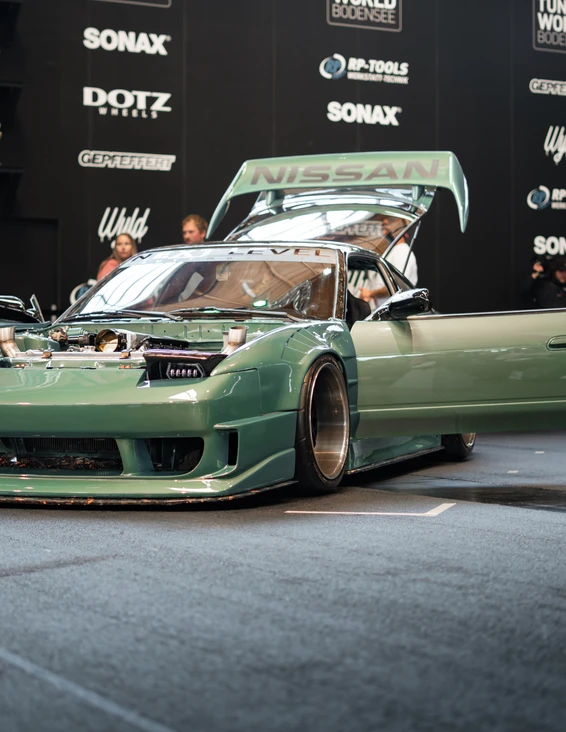 Tuning World Bodensee 2026, grün lackiertes Nissan Fahrzeug. Nissan Fahrzeug mit offenen Türen auf der Tuning World Bodensee 2026